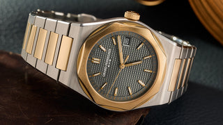 Two-tone Girard-Perregaux Laureato watch with gold bezel, steel bracelet, gray textured dial and date at 3.