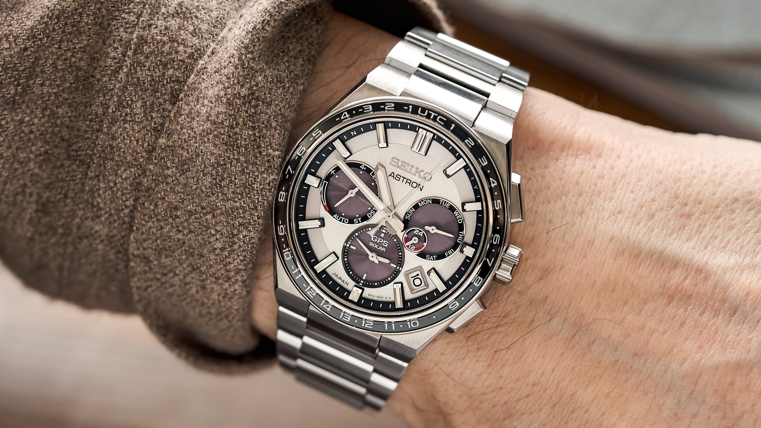 Best Solar Watches: Seiko Astron solar GPS watch with silver dial, black bezel and multiple subdials on a stainless steel bracelet