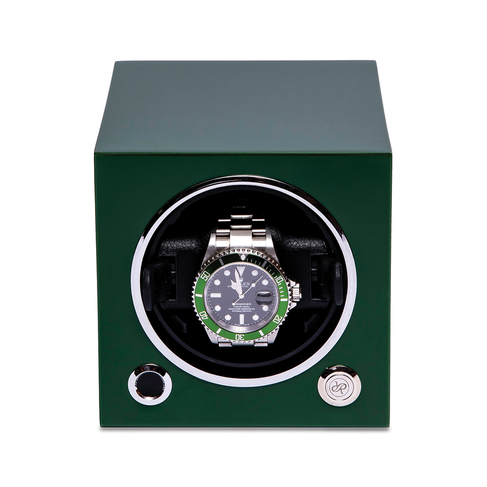 Green single watch winder with round window showing a silver Rolex watch
