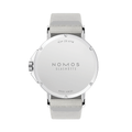 Back view of Ahoi Neomatik Sand watch with beige fabric strap and polished stainless steel case back.