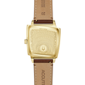 Gold-toned cushion-shaped watch back with engraved case back and brown leather strap