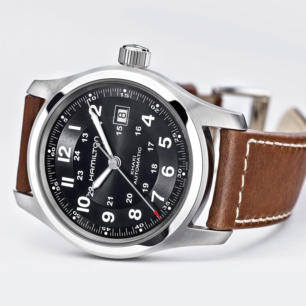 Close-up of Khaki Field Auto 42mm watch face showing crown and date window