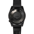Back view of a black DLC watch with a dark strap and circular engraved case back