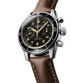 Longines Spirit Pilot Flyback watch with black dial gold numerals and brown leather strap.