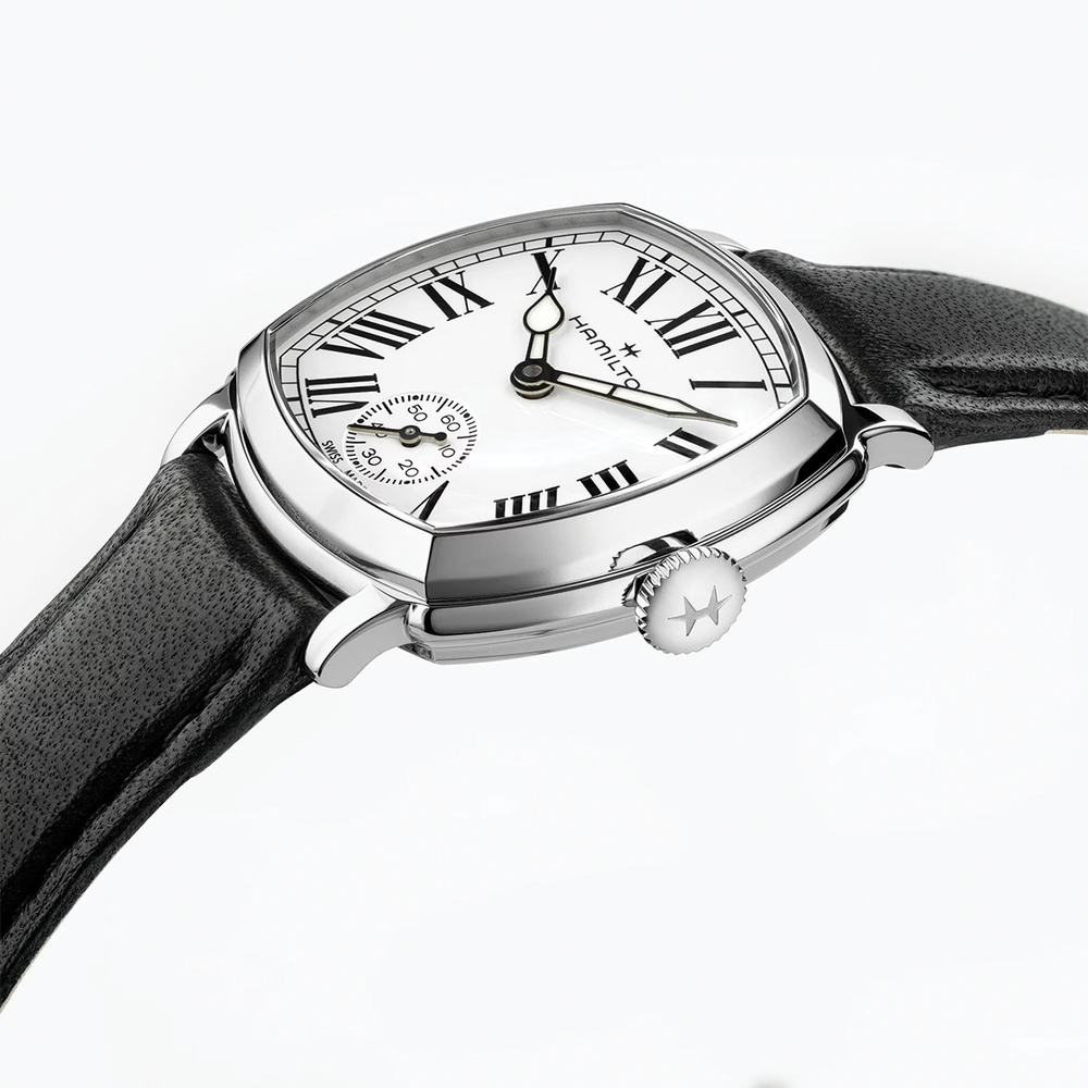 Close up of cushion shaped Hamilton watch with white dial Roman numerals and black leather strap