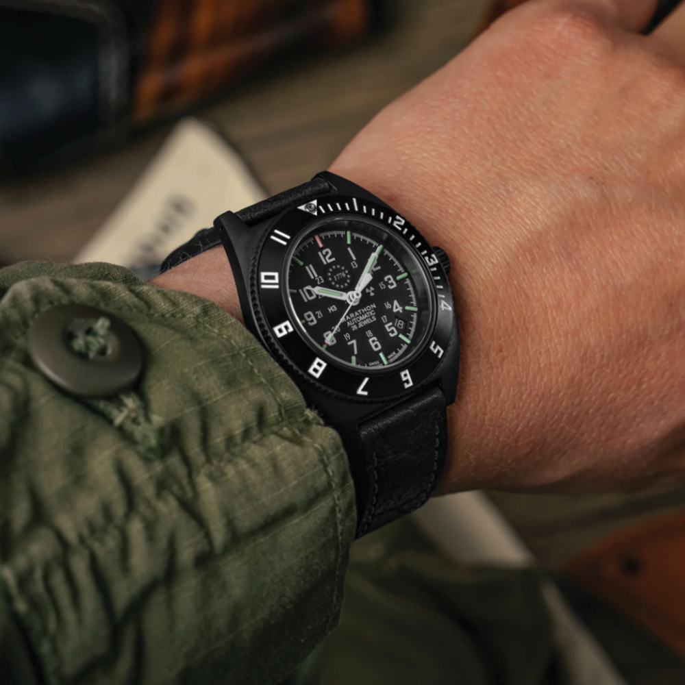 Wrist shot of SSNAV-D Auto U.S. 250 Limited Edition 41mm black dial on black rubber strap with green lume