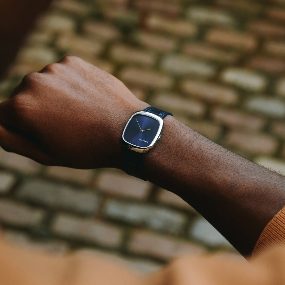 Wrist wearing ALD Time Only Sunray Blue steel watch on a blue leather strap.