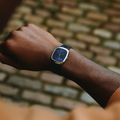 Wrist wearing ALD Time Only Sunray Blue steel watch on a blue leather strap.