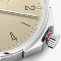 Close up of Ahoi Neomatik Sand beige dial with textured surface and polished steel case.