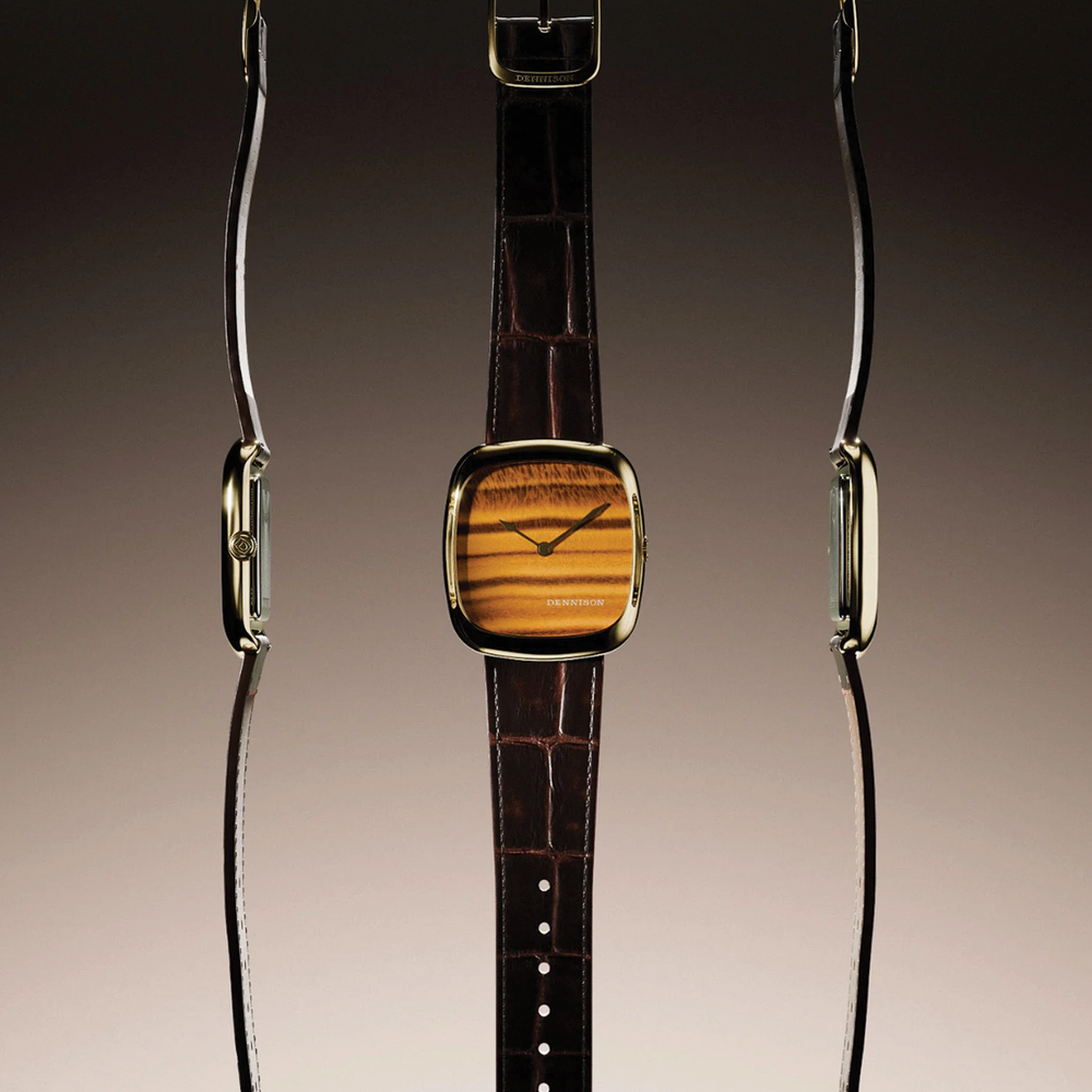 Front and side views of a Dennison tiger eye time only watch in gold case on brown leather strap