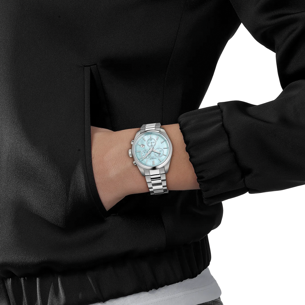 Wrist wearing Tissot PR 100 Quartz Chronograph 36mm blue mother-of-pearl dial on stainless steel bracelet