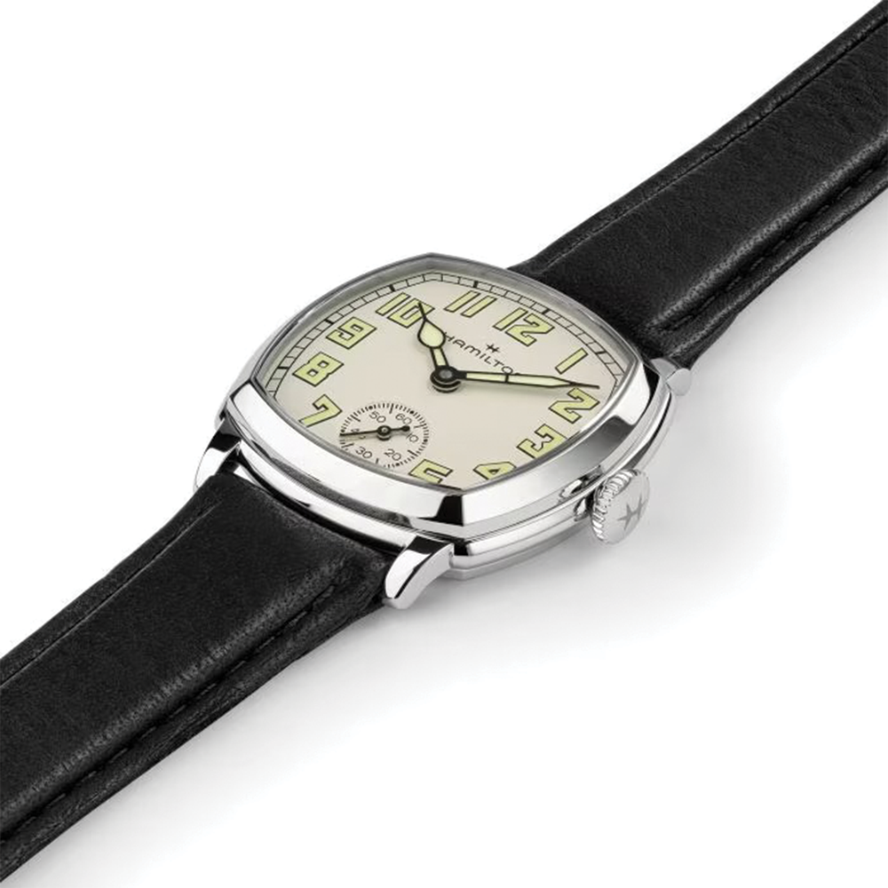 Side view of cushion shaped American Classic Mechanical watch with beige dial on black leather strap