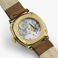 Gold tone case back of cushion style Hamilton watch showing exposed movement and brown leather strap.