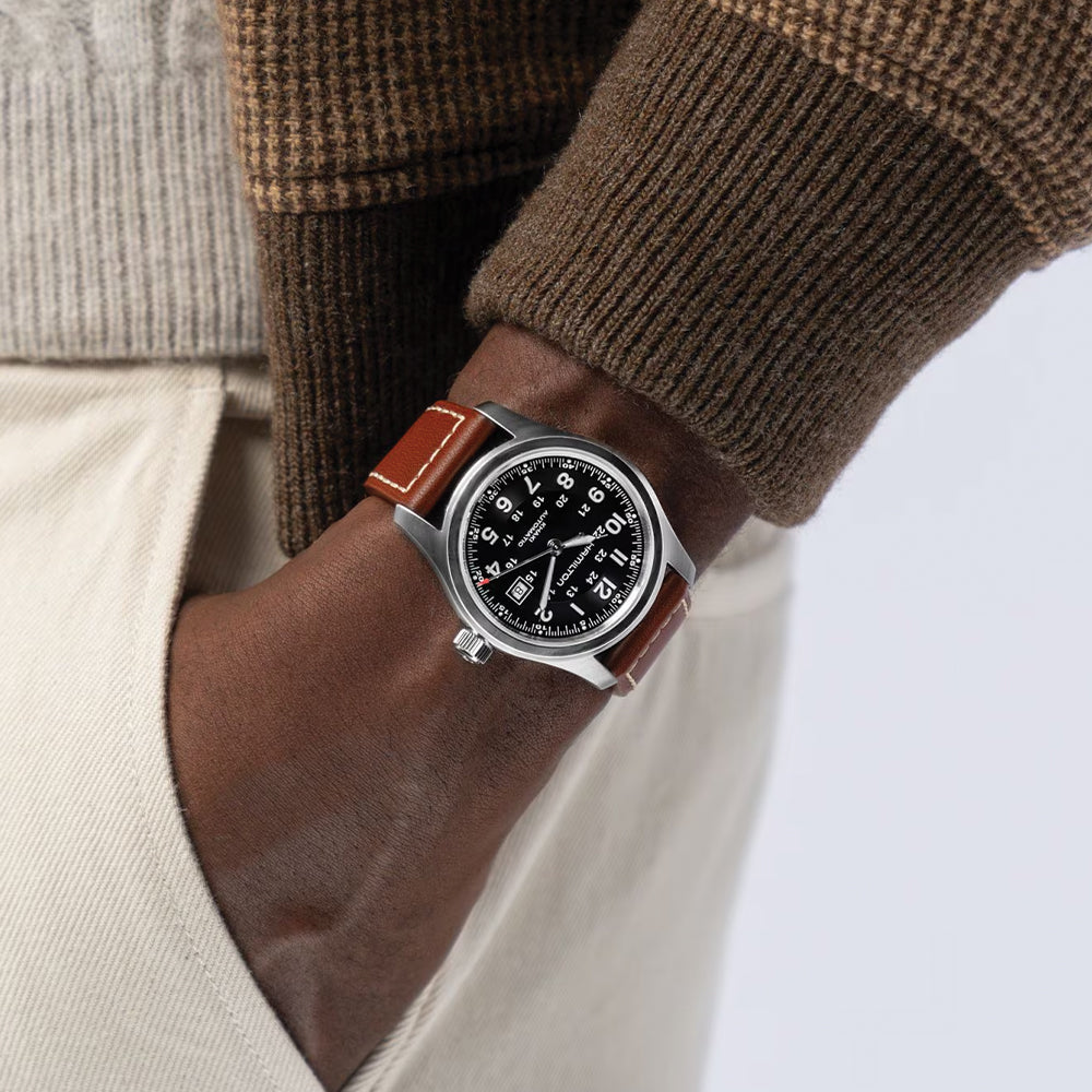 Khaki Field Auto 42mm wristwatch on brown leather strap worn on the wrist