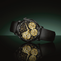 Spaceview Evolution 43.5mm watch with black case and leather strap featuring gold skeleton gears on a dark marbled dial and reflection.