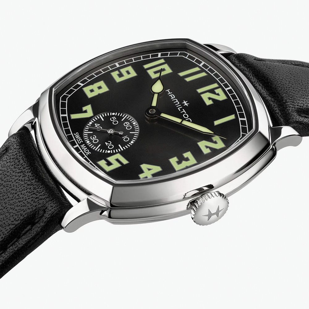 Close-up of American Classic Cushion Mechanical 34mm watch showing a black dial with oversized luminous numerals and a small seconds subdial.