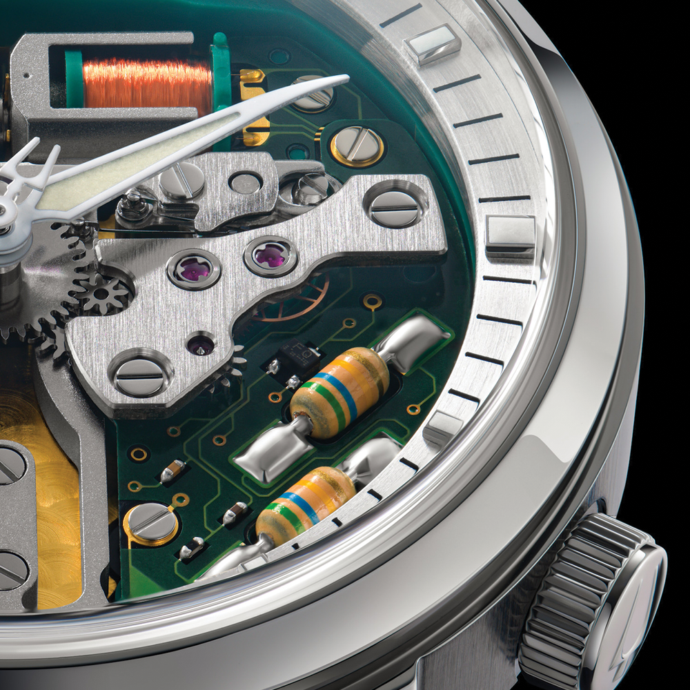 Macro view of the Spaceview 314 movement edge with gears green circuit board and striped resistors