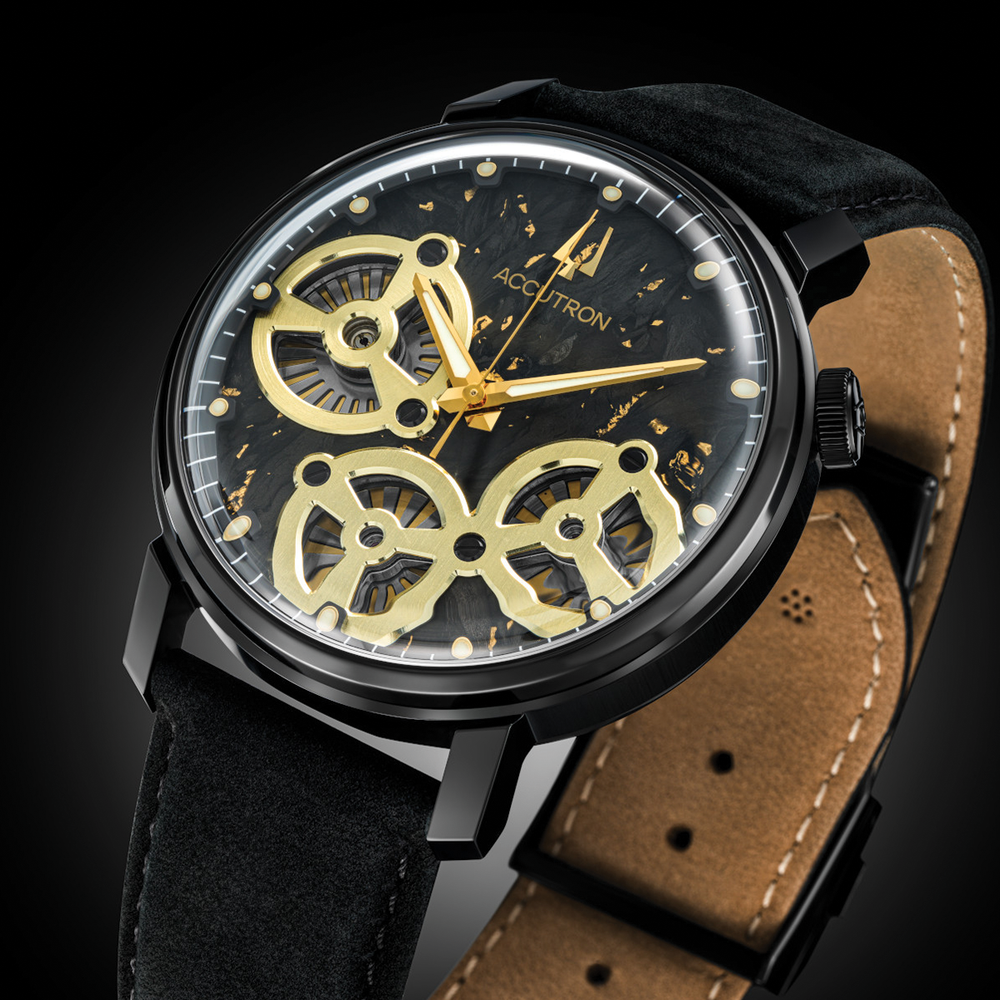 Spaceview Evolution 43.5mm black case watch with gold skeleton gears on a dark dial and black leather strap with tan underside.