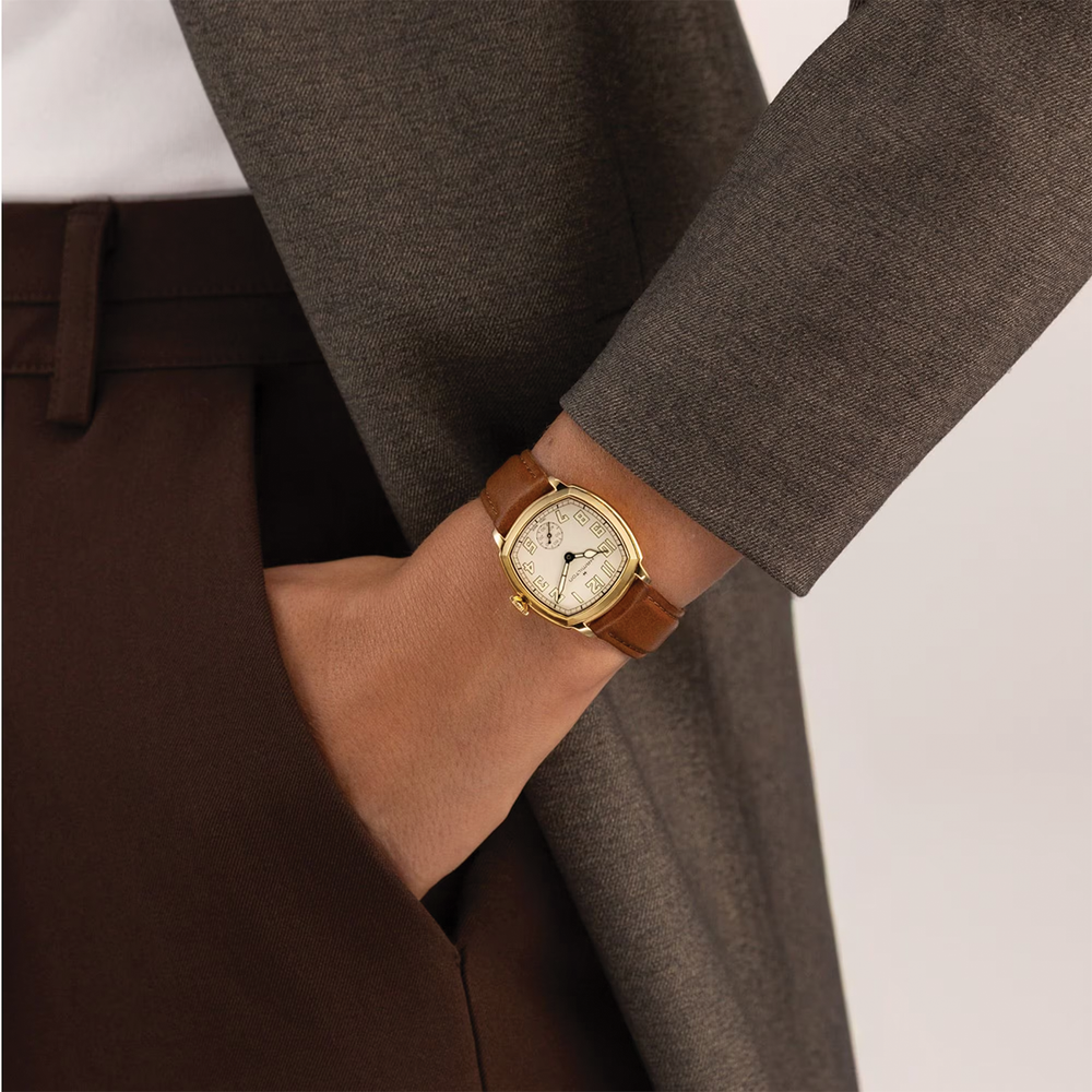 Wrist shot of the Hamilton American Classic Cushion Mechanical watch with beige dial on a brown leather strap