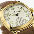 Close-up of a gold-tone cushion watch with beige leather strap and Hamilton branding