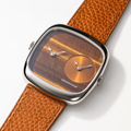 Close up of ALD Dual Time Tiger Eye and Gold Sunray dial watch with tan leather strap