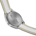 Rear view of Tissot PR 100 watch showing stainless steel case back with engravings and striped fabric strap