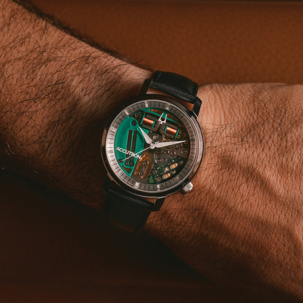 Wrist shot of Tuning Fork Spaceview 314 39mm featuring a teal green skeleton dial and black leather strap.