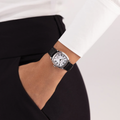 Wrist shot of the cushion mechanical watch on a black leather strap worn with a white shirt.