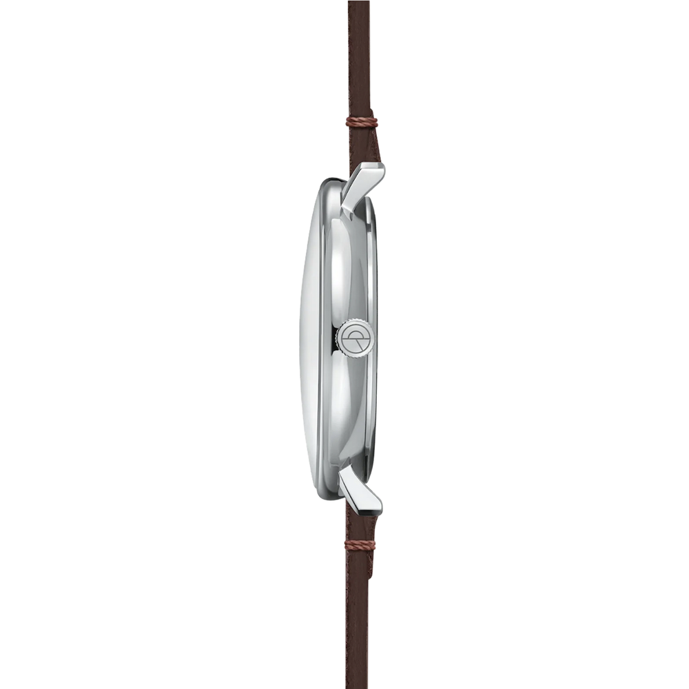 Side view of stainless steel watch case with brown leather strap