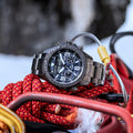 Rugged black watch with bold numerals rests on a red climbing rope outdoors