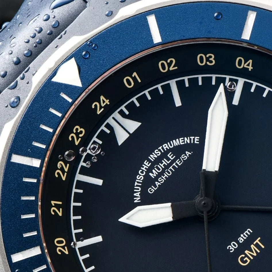 Close-up of Seebataillon GMT dial with gold 24-hour numerals and white hands.