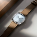 Close up of ALD Time Only Sunray Ice Blue steel watch with blue sunburst dial and brown leather strap